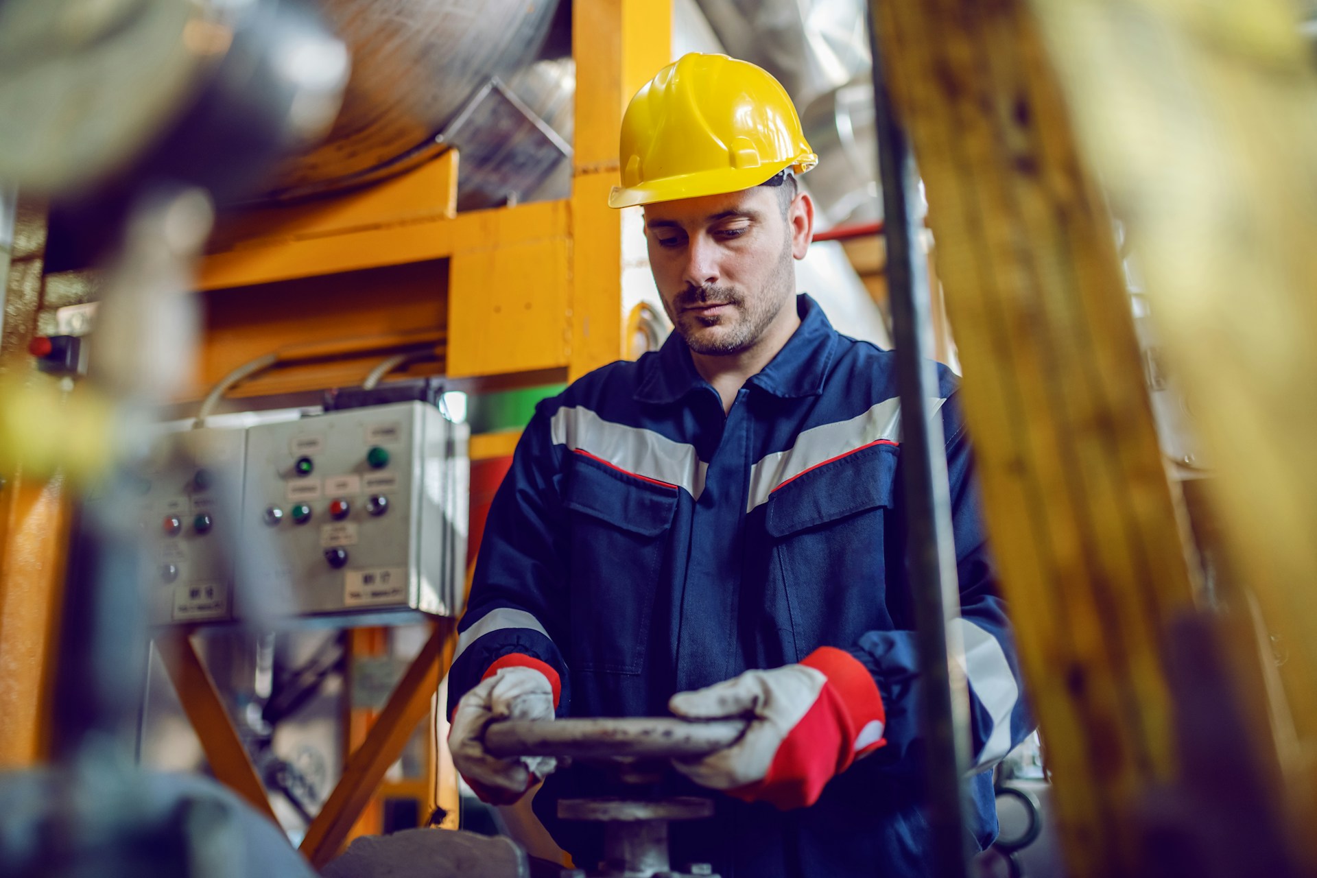 Worker twisting a valve