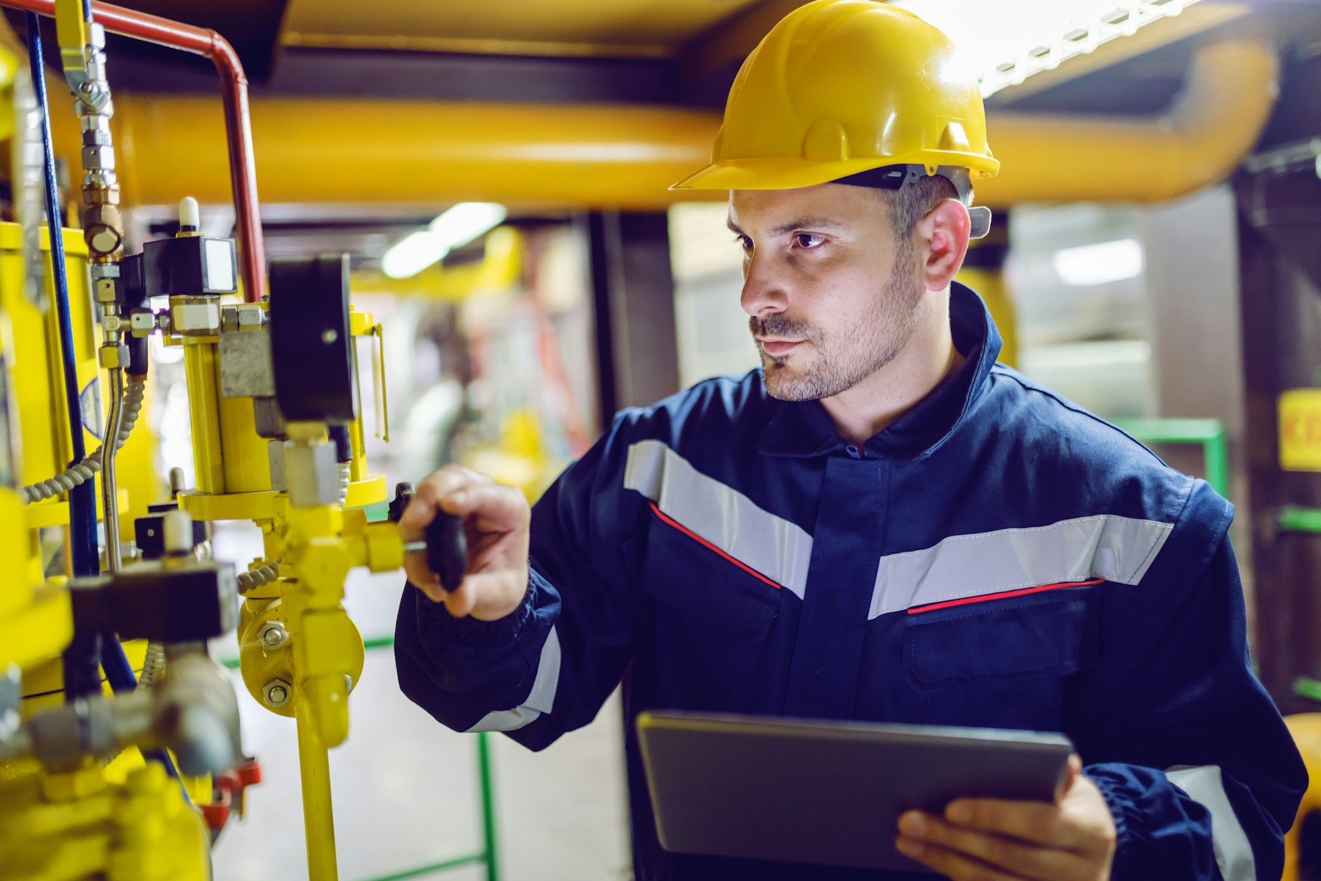 A worker checking a machine