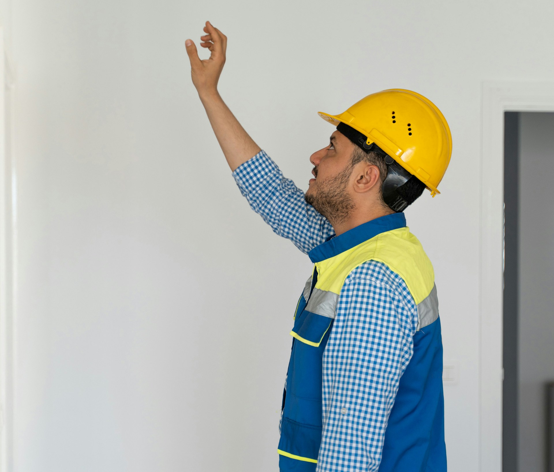 A man with hard hat points at something