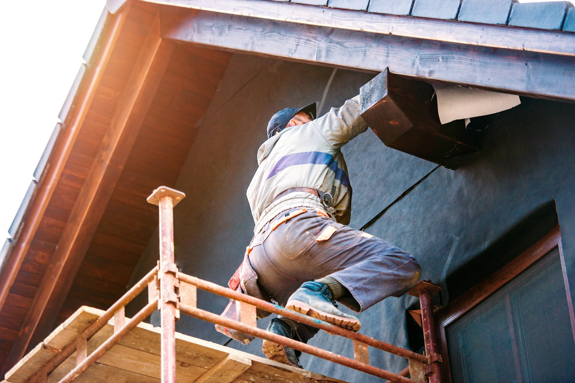 A worker standing outside the house