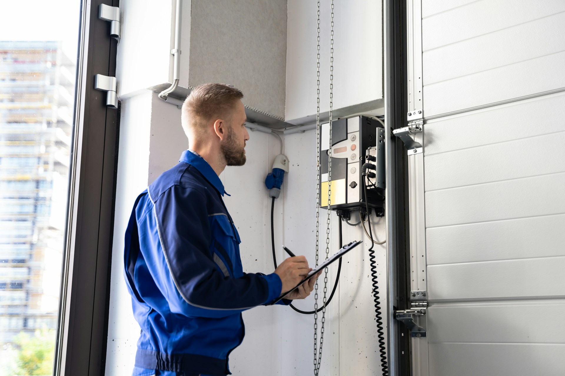 A man looking at a switch on a wall