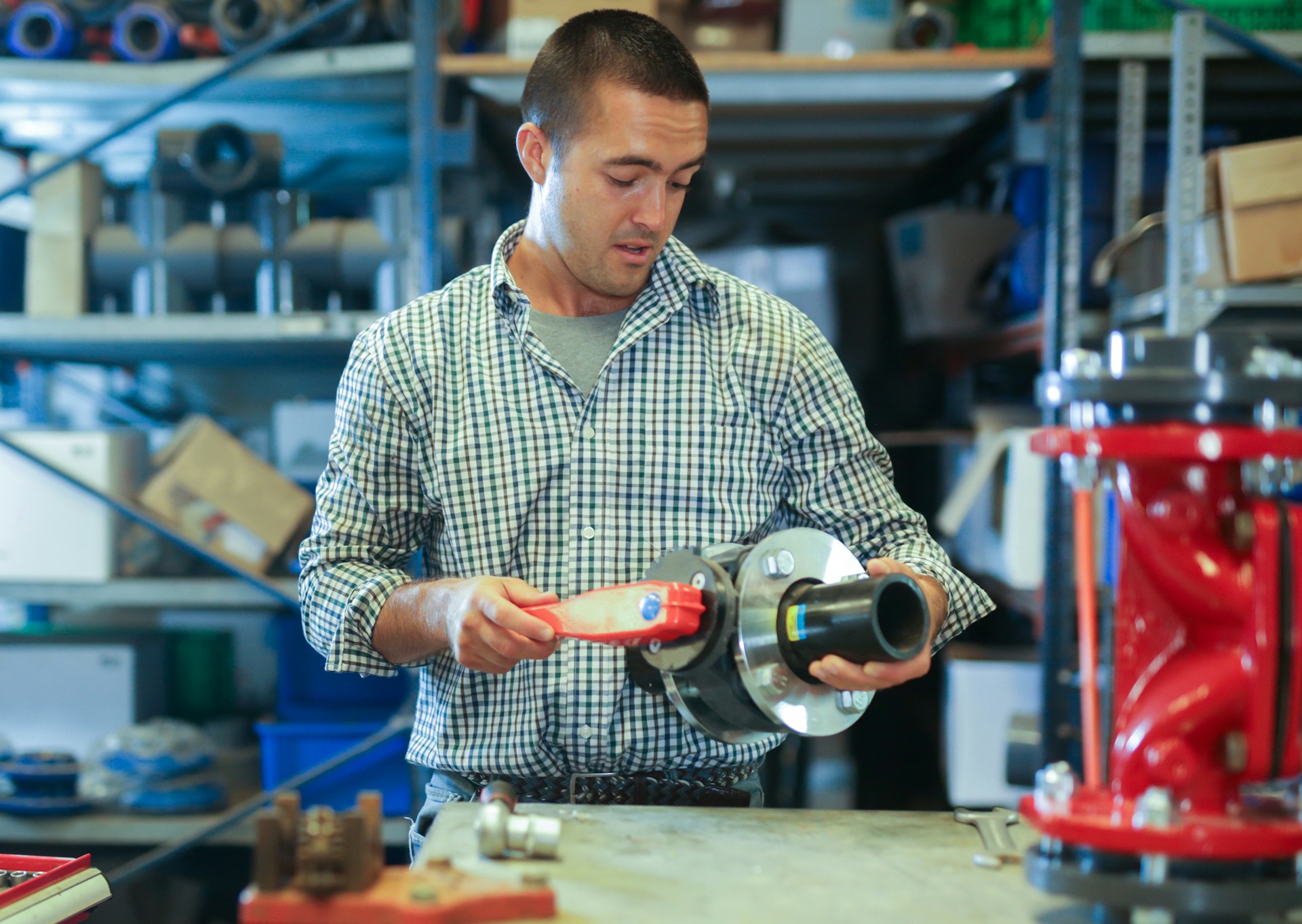 A man holding a machine part