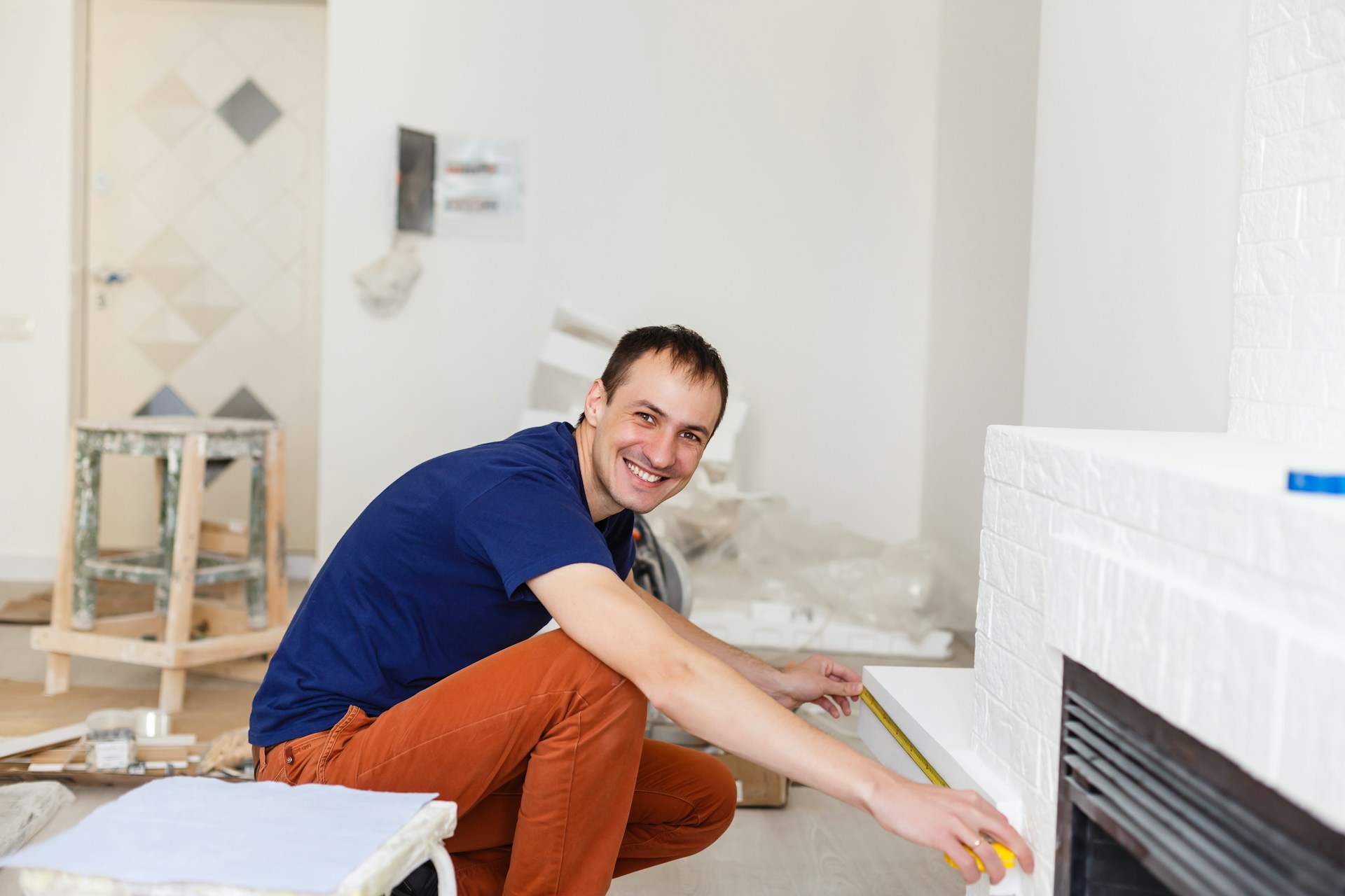 A person holding a hand tool smiling