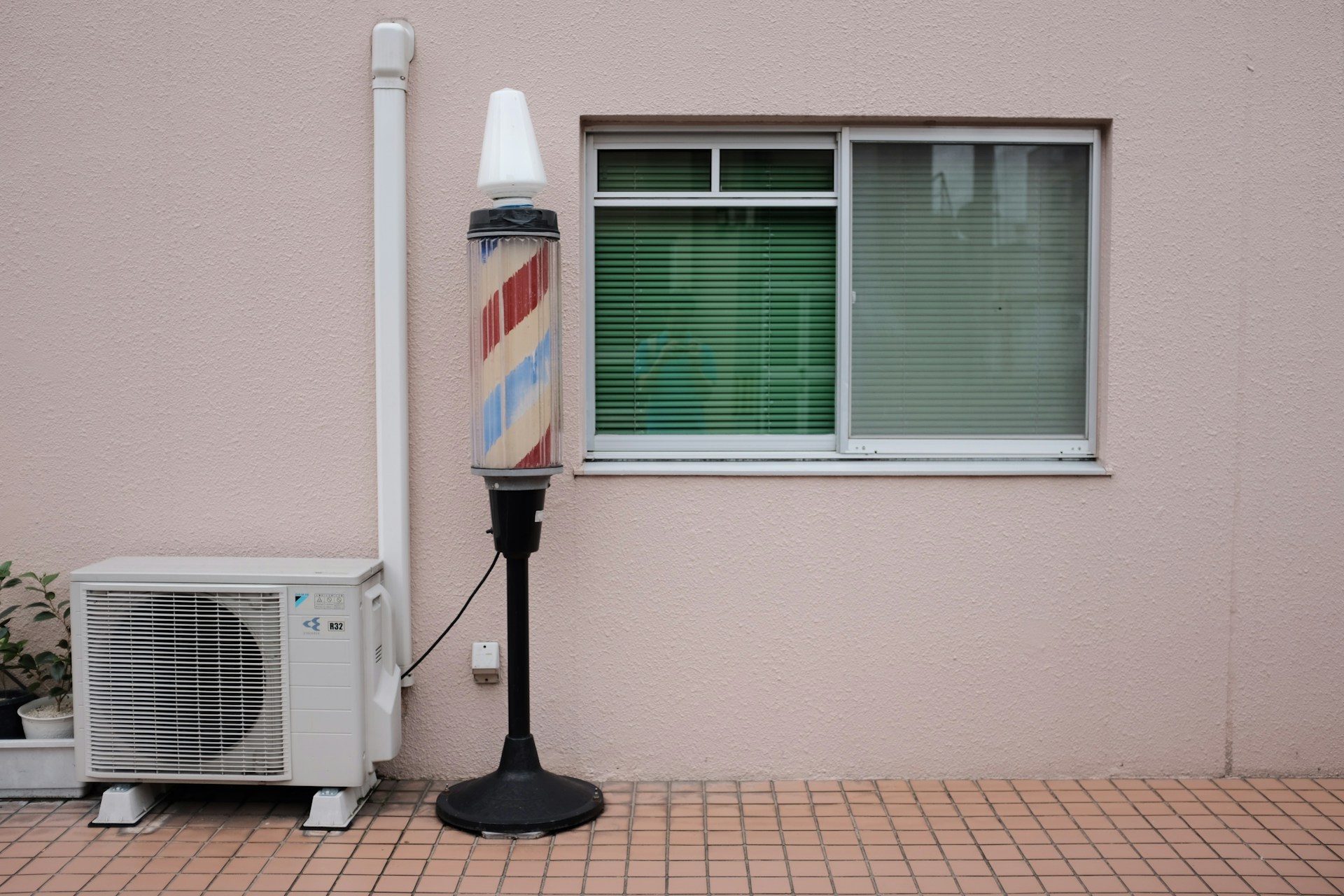 A barbers lamp beside an air condenser